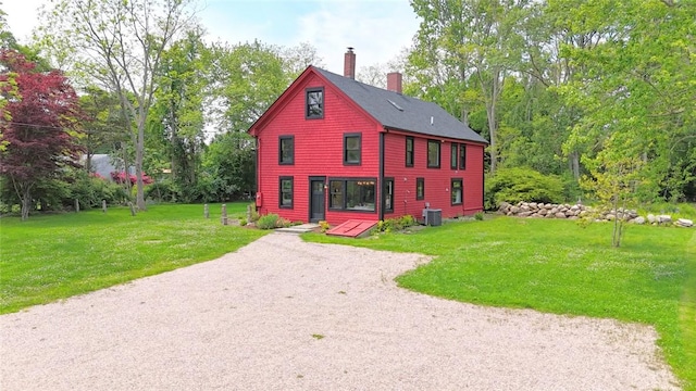 259 Green Hill Beach Rd, South Kingstown, RI 02879 - view of front of house with a chimney, a front lawn, and cooling unit