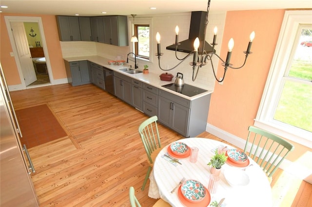 259 Green Hill Beach Rd, South Kingstown, RI 02879 - kitchen with gray cabinets, wall chimney exhaust hood, black electric stovetop, a sink, and dishwashing machine