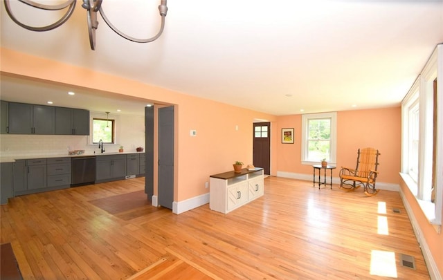 259 Green Hill Beach Rd, South Kingstown, RI 02879 - unfurnished living room with light wood-style floors, baseboards, a sink, and recessed lighting