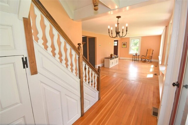 259 Green Hill Beach Rd, South Kingstown, RI 02879 - stairs featuring a chandelier, wood finished floors, and baseboards