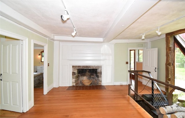 259 Green Hill Beach Rd, South Kingstown, RI 02879 - living area with rail lighting, light wood finished floors, a high end fireplace, and baseboards