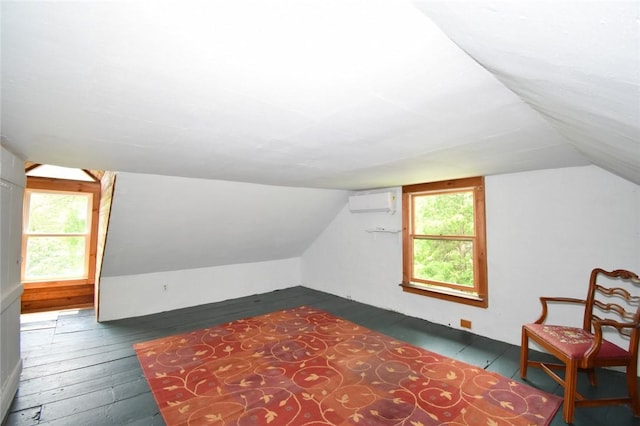 259 Green Hill Beach Rd, South Kingstown, RI 02879 - additional living space with lofted ceiling, dark wood-style flooring, and an AC wall unit