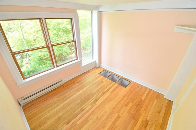 259 Green Hill Beach Rd, South Kingstown, RI 02879 - unfurnished room with a baseboard radiator, light wood-style flooring, and baseboards