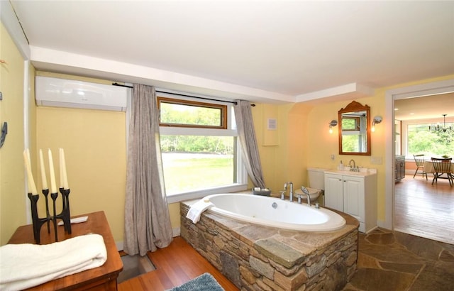 259 Green Hill Beach Rd, South Kingstown, RI 02879 - bathroom with a wall unit AC, a whirlpool tub, vanity, and wood finished floors