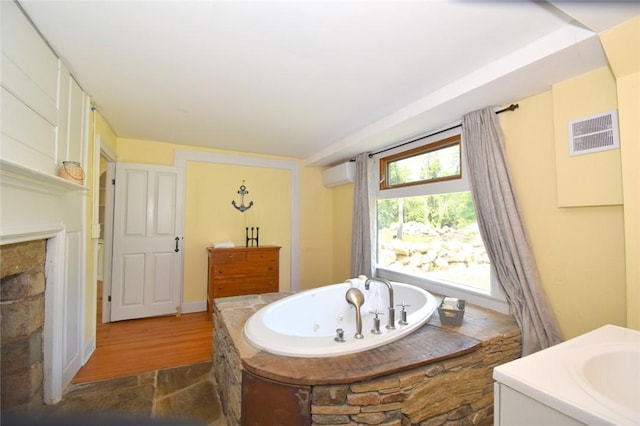 259 Green Hill Beach Rd, South Kingstown, RI 02879 - full bathroom featuring a whirlpool tub, a wall unit AC, vanity, and wood finished floors