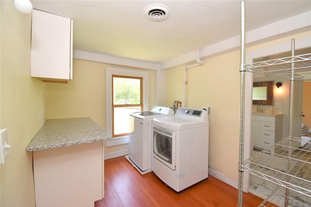 259 Green Hill Beach Rd, South Kingstown, RI 02879 - laundry area with independent washer and dryer and light wood-type flooring