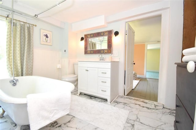 259 Green Hill Beach Rd, South Kingstown, RI 02879 - bathroom featuring marble look tiles, a soaking tub, wainscoting, vanity, and a shower with shower curtain