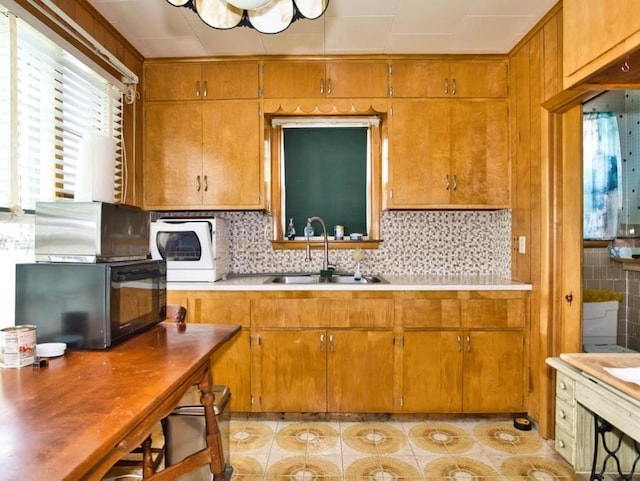 127 Pettey Ln, Westport, MA 02790 - kitchen with a sink, brown cabinetry, light tile patterned floors, and light countertops