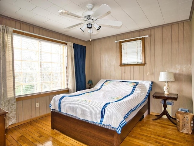 127 Pettey Ln, Westport, MA 02790 - bedroom with wood-type flooring, wooden walls, baseboards, and a ceiling fan