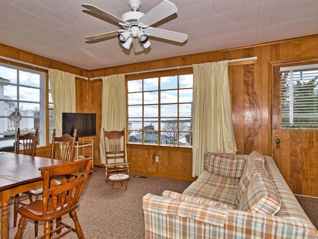 127 Pettey Ln, Westport, MA 02790 - living room with wood walls, carpet floors, plenty of natural light, and ceiling fan