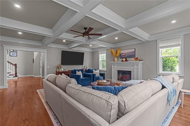 40 Oakbrook Ct, East Greenwich, RI 02818 - living room featuring stairs, wood finished floors, a stone fireplace, beamed ceiling, and baseboards