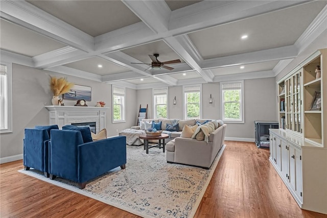 40 Oakbrook Ct, East Greenwich, RI 02818 - living area featuring a fireplace, light wood-type flooring, baseboards, a ceiling fan, and beamed ceiling