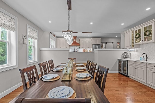 40 Oakbrook Ct, East Greenwich, RI 02818 - dining room with wine cooler, light wood-style flooring, recessed lighting, baseboards, and a chandelier