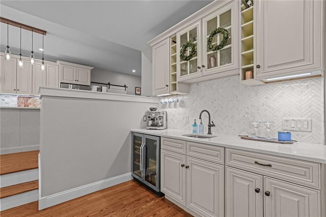40 Oakbrook Ct, East Greenwich, RI 02818 - bar with beverage cooler, a sink, backsplash, and light wood-type flooring