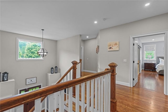40 Oakbrook Ct, East Greenwich, RI 02818 - hallway with an upstairs landing, light wood finished floors, a chandelier, recessed lighting, and baseboards