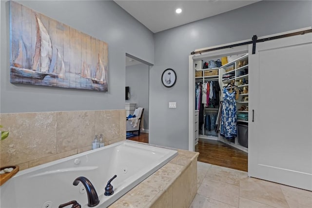 40 Oakbrook Ct, East Greenwich, RI 02818 - bathroom featuring a jetted tub, a spacious closet, and recessed lighting
