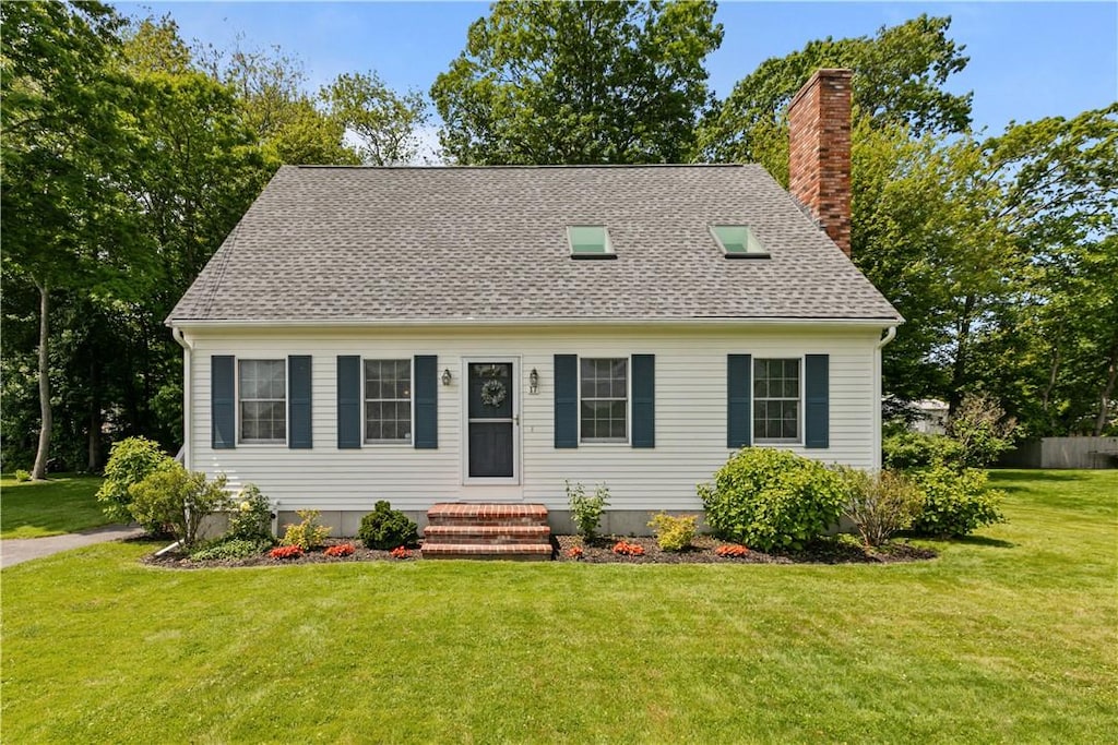 17 Basswood Dr, Bristol, RI 02809 - new england style home with a chimney, a front yard, and roof with shingles