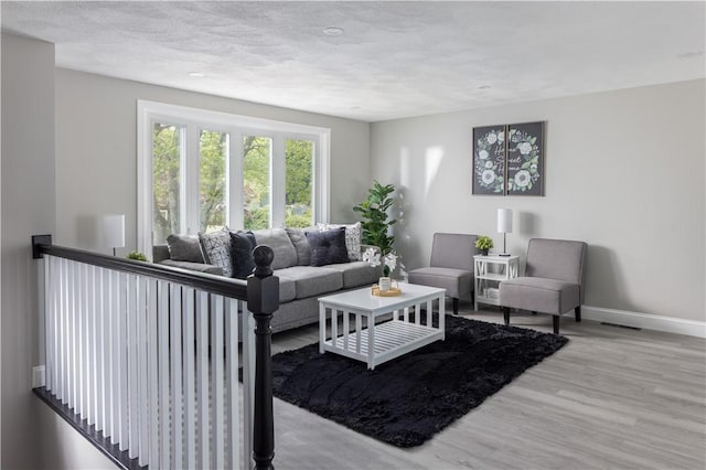 99 Scranton Ave, Warwick, RI 02888 - living area with baseboards, wood finished floors, and a textured ceiling