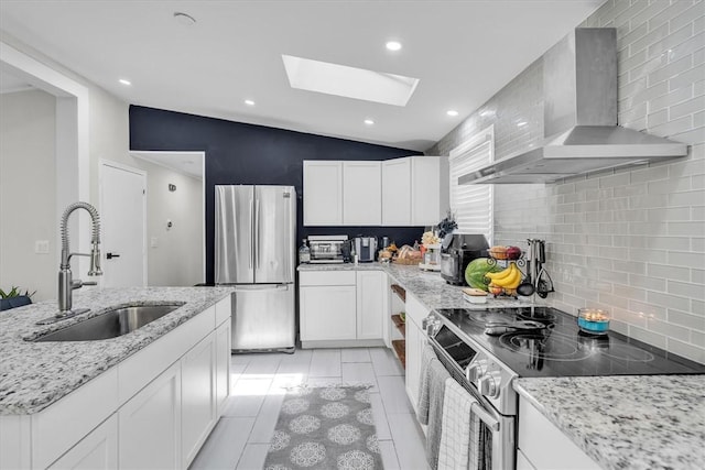 202 Hartford Pike, Foster, RI 02825 - kitchen featuring stainless steel appliances, wall chimney exhaust hood, a sink, tasteful backsplash, and a skylight