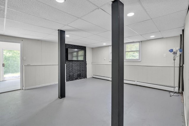 202 Hartford Pike, Foster, RI 02825 - below grade area featuring a drop ceiling, healthy amount of natural light, and a baseboard heating unit