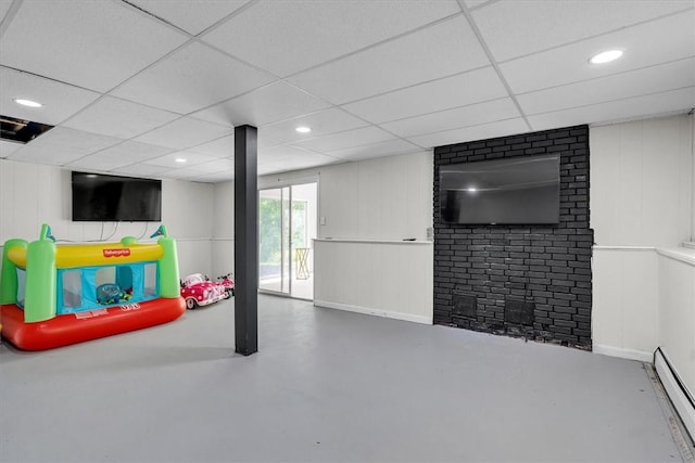 202 Hartford Pike, Foster, RI 02825 - basement featuring a baseboard heating unit, a paneled ceiling, a decorative wall, and recessed lighting
