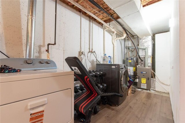 15 Loyalist Dr Unit 15B, Uxbridge, MA 01569 - unfinished basement with wood finished floors, water heater, and independent washer and dryer