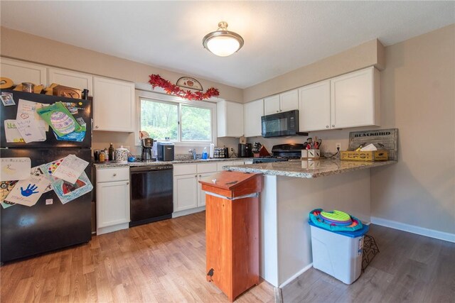 15 Loyalist Dr Unit 15B, Uxbridge, MA 01569 - kitchen with black appliances, a peninsula, light wood-style floors, and white cabinetry