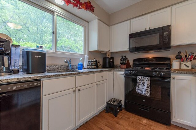 15 Loyalist Dr Unit 15B, Uxbridge, MA 01569 - kitchen with black appliances, a sink, white cabinetry, and light wood-style flooring