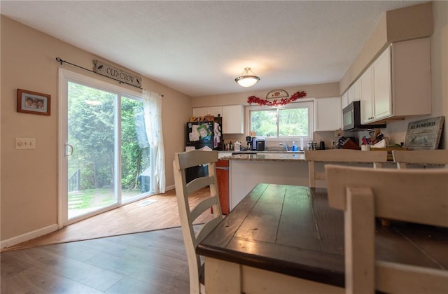 15 Loyalist Dr Unit 15B, Uxbridge, MA 01569 - kitchen featuring black appliances, white cabinets, a peninsula, baseboards, and light wood finished floors