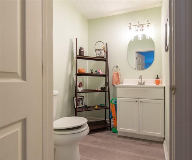 15 Loyalist Dr Unit 15B, Uxbridge, MA 01569 - bathroom featuring toilet, vanity, and wood finished floors