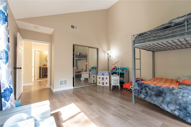 15 Loyalist Dr Unit 15B, Uxbridge, MA 01569 - bedroom featuring high vaulted ceiling, wood finished floors, a closet, and baseboards