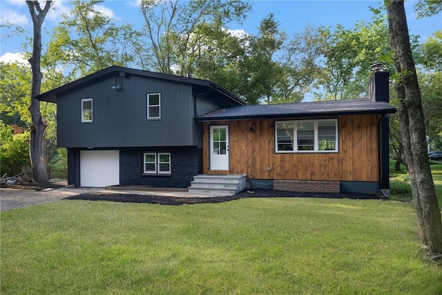 7 Nichols Rd, South Kingstown, RI 02881 - tri-level home with a front yard, a chimney, a garage, and driveway