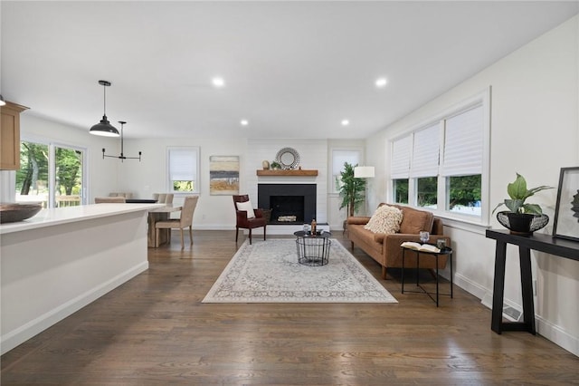 7 Nichols Rd, South Kingstown, RI 02881 - living area with dark wood-type flooring, baseboards, a brick fireplace, and recessed lighting