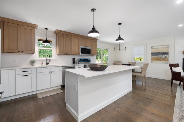 7 Nichols Rd, South Kingstown, RI 02881 - kitchen with appliances with stainless steel finishes, a sink, light countertops, and dark wood-style floors