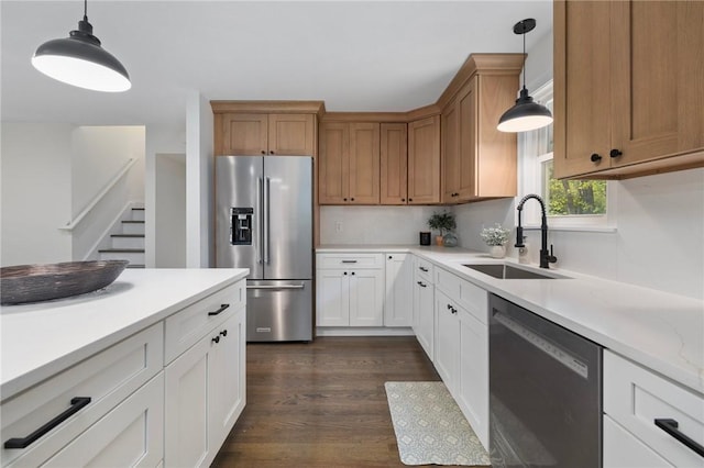7 Nichols Rd, South Kingstown, RI 02881 - kitchen with stainless steel appliances, a sink, light countertops, pendant lighting, and dark wood-style flooring