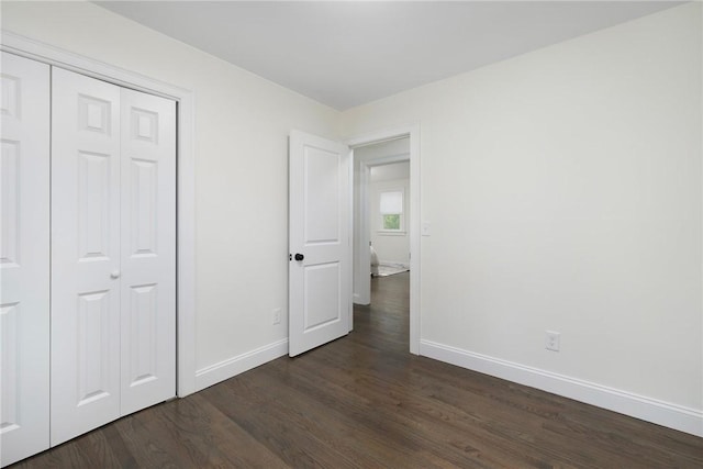 7 Nichols Rd, South Kingstown, RI 02881 - unfurnished bedroom with baseboards, dark wood-style floors, and a closet