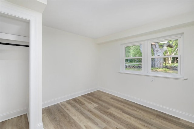 7 Nichols Rd, South Kingstown, RI 02881 - unfurnished bedroom with light wood-style floors, baseboards, and a closet