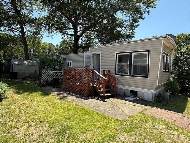 6101 Post Rd, North Kingstown, RI 02852 - back of property featuring a yard and a wooden deck