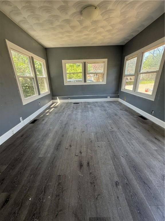6101 Post Rd, North Kingstown, RI 02852 - empty room with dark wood finished floors and baseboards
