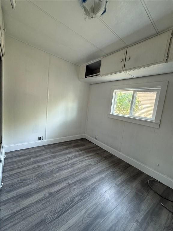 6101 Post Rd, North Kingstown, RI 02852 - unfurnished room with dark wood-style flooring and baseboards