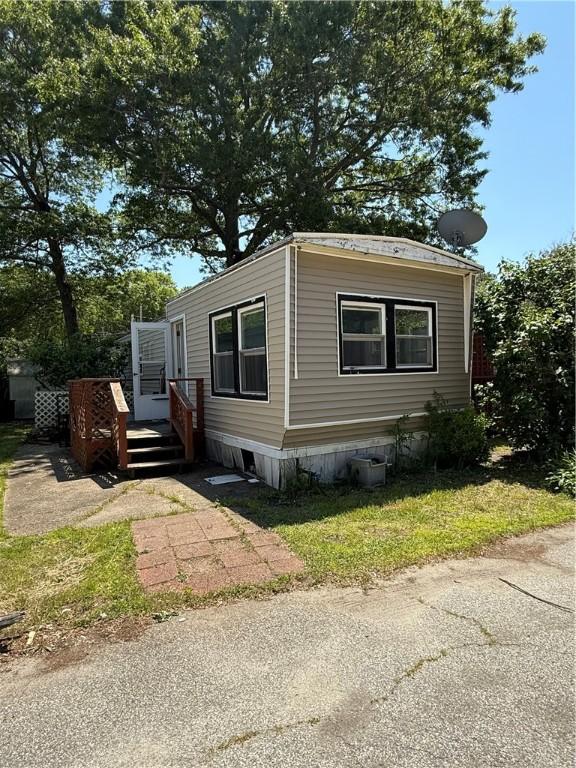6101 Post Rd, North Kingstown, RI 02852 - manufactured / mobile home with a wooden deck