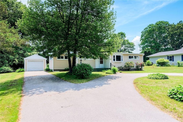 7 Stuart St, Westerly, RI 02891 - view of front of property featuring an outbuilding, asphalt driveway, a front lawn, and a garage