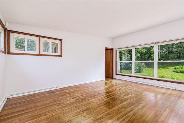 7 Stuart St, Westerly, RI 02891 - unfurnished room with a baseboard radiator, wood-type flooring, baseboards, and a baseboard heating unit