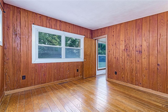 7 Stuart St, Westerly, RI 02891 - spare room with hardwood / wood-style floors, plenty of natural light, wooden walls, and baseboards