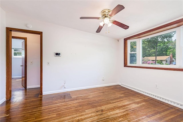 7 Stuart St, Westerly, RI 02891 - spare room featuring a baseboard radiator, plenty of natural light, wood finished floors, and baseboards