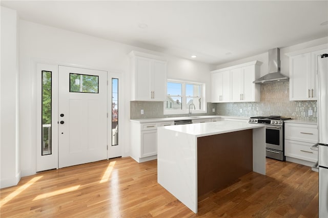 41 Burnett Rd, Warwick, RI 02889 - kitchen featuring wall chimney exhaust hood, appliances with stainless steel finishes, light countertops, tasteful backsplash, and recessed lighting