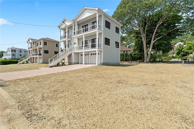 41 Burnett Rd, Warwick, RI 02889 - view of front facade with a balcony, driveway, a garage, and stairway