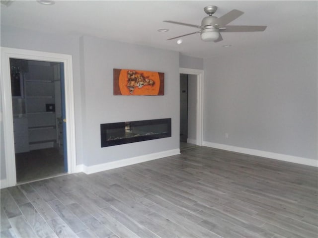 176 Vernon St, Warwick, RI 02889 - unfurnished living room with a glass covered fireplace, wood finished floors, baseboards, and recessed lighting
