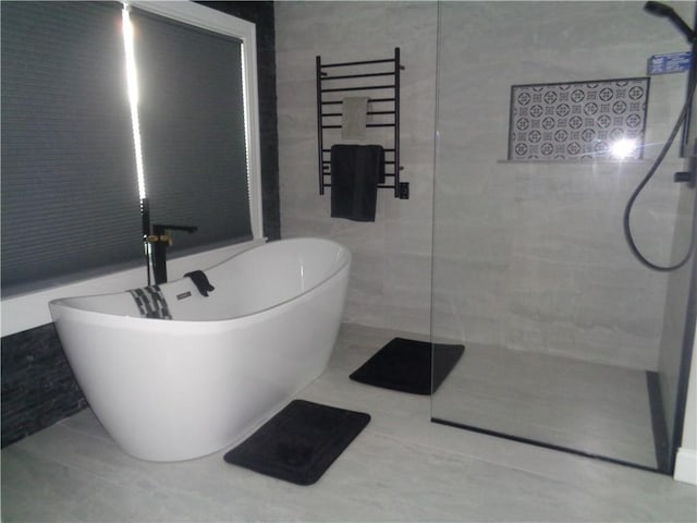 176 Vernon St, Warwick, RI 02889 - full bathroom featuring walk in shower, a towel warming rack, tile walls, and a soaking tub