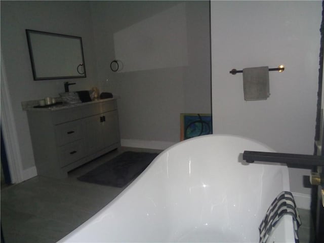 176 Vernon St, Warwick, RI 02889 - full bath with a freestanding tub, vanity, and baseboards
